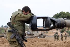 Soldier rests his head on the muzzle of a tank